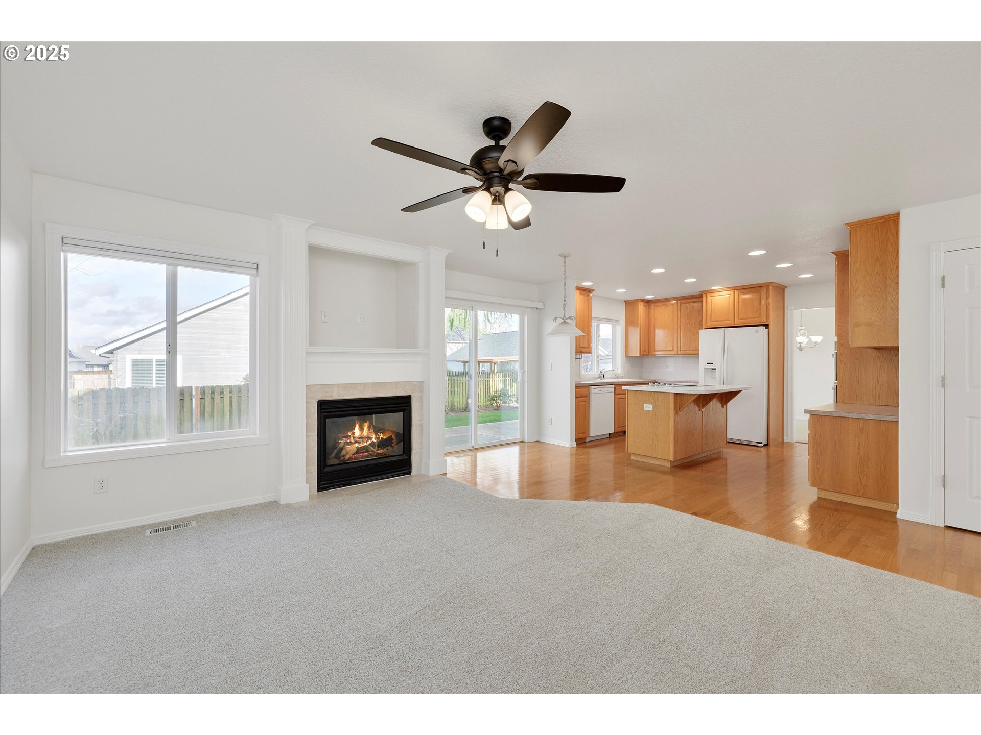 1380 Southeast 9th Avenue Canby, OR 97013 - Photo 5 of 21 a view of a livingroom with a fireplace a ceiling fan and windows