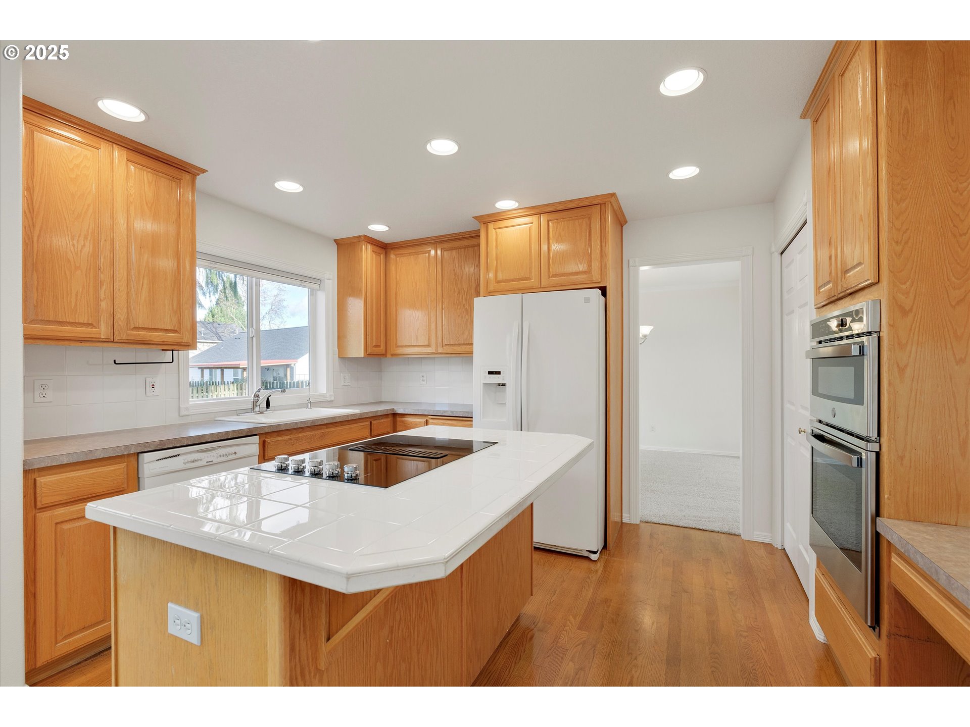 1380 Southeast 9th Avenue Canby, OR 97013 - Photo 6 of 21 a kitchen that has a sink a refrigerator and a stove top oven