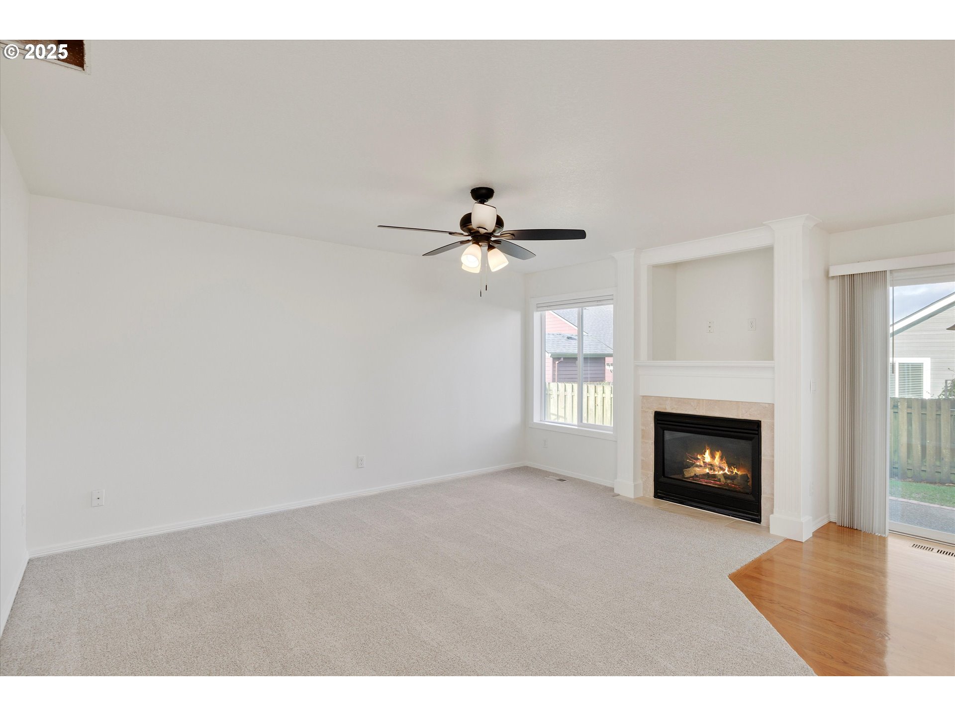 1380 Southeast 9th Avenue Canby, OR 97013 - Photo 9 of 21 a view of a livingroom with a fireplace and a ceiling fan