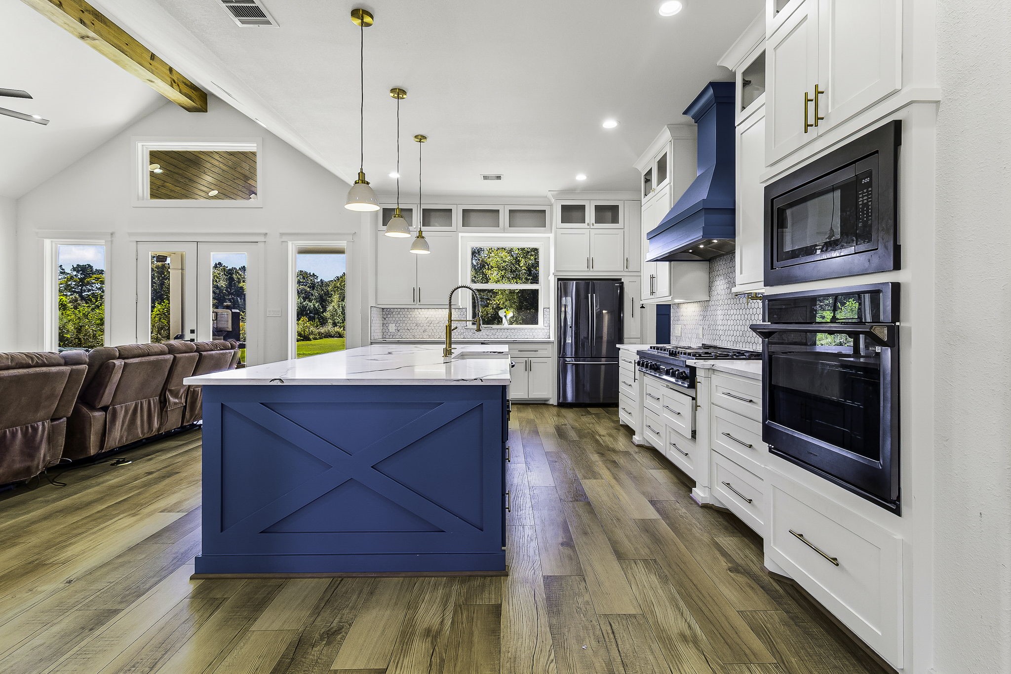440 Farm To Market 223 Shepherd, TX 77371 - Photo 13 of 40 a large kitchen with stainless steel appliances wooden floor and a view of living room