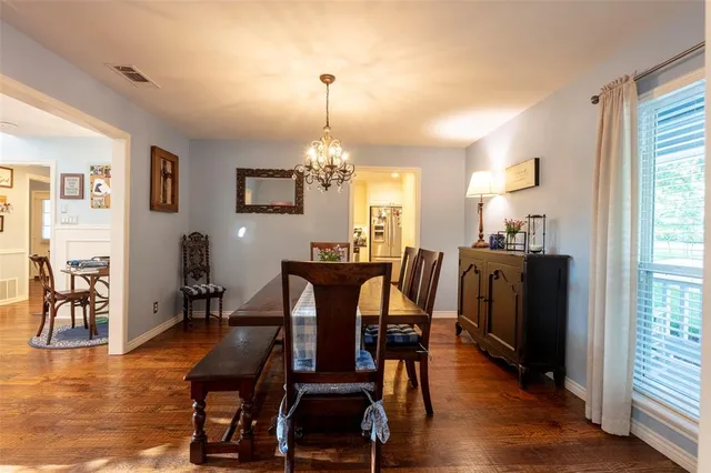 a living room with furniture a fireplace and kitchen view