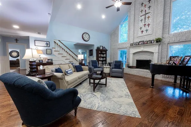 a living room with furniture wooden floor and a clock