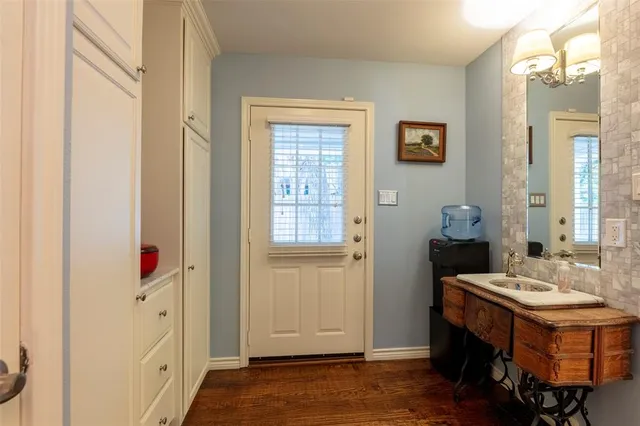 a kitchen with stainless steel appliances granite countertop a table chairs sink and cabinets