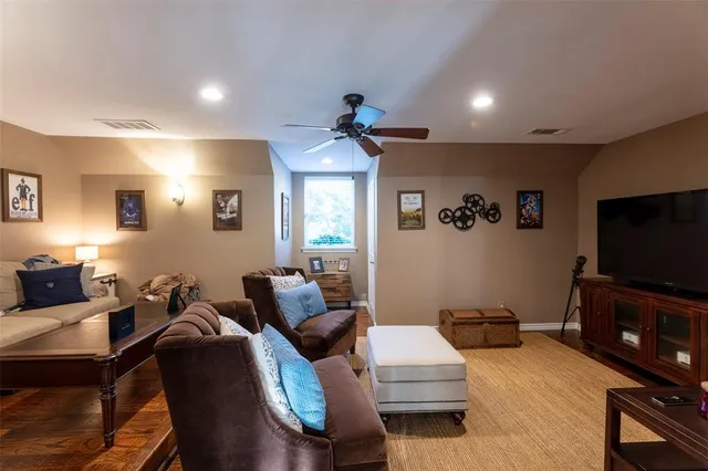 a living room with furniture a rug and a chandelier