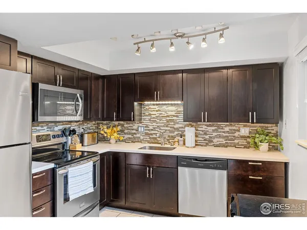 a kitchen with a sink a stove and cabinets