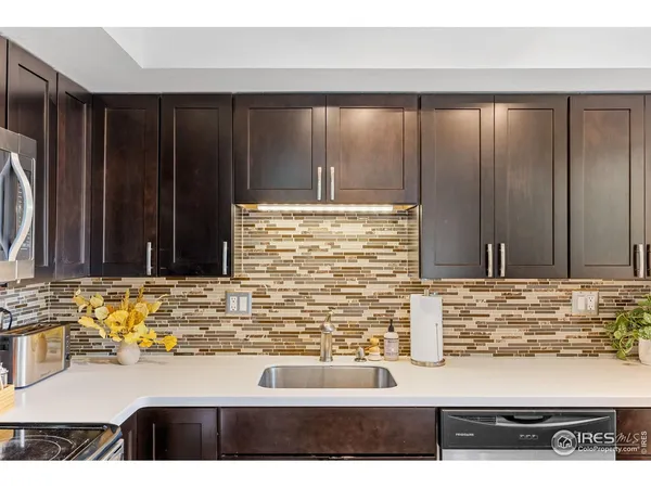 a kitchen with a sink and a wooden cabinets