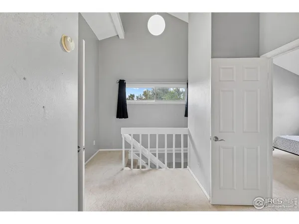 a view of a bedroom with wooden floor