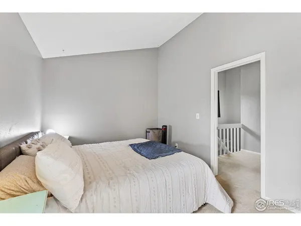 a bedroom with a bed and a chair