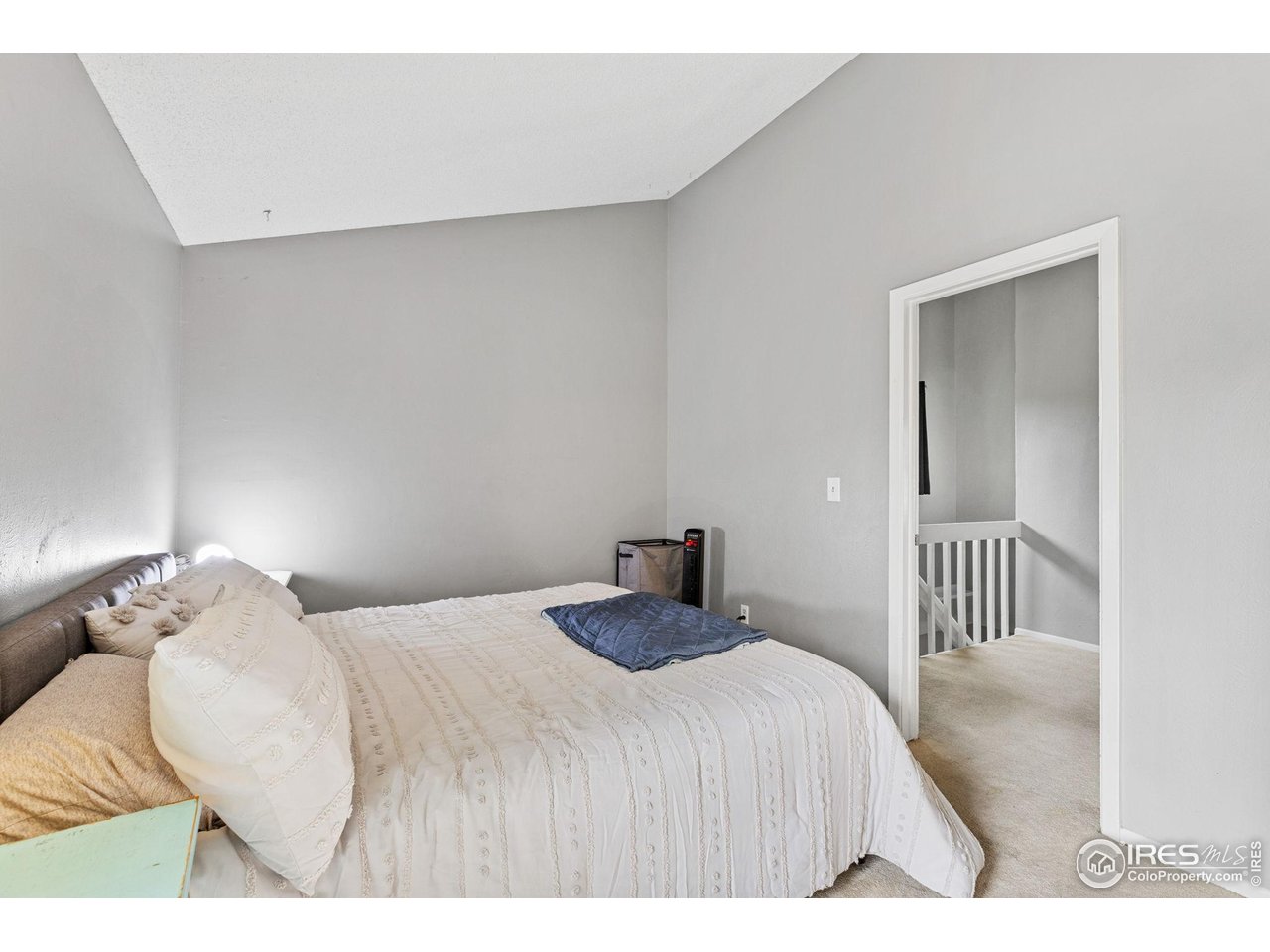 4216 East Maplewood Way Centennial, CO 80121 - Photo 21 of 46 a bedroom with a bed and a chair