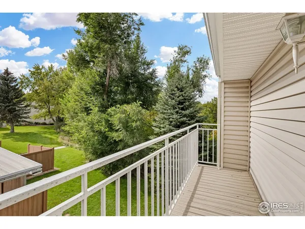 a balcony with wooden floor and fence