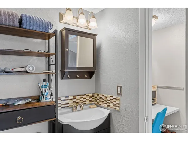 a bathroom with a sink a mirror and a toilet