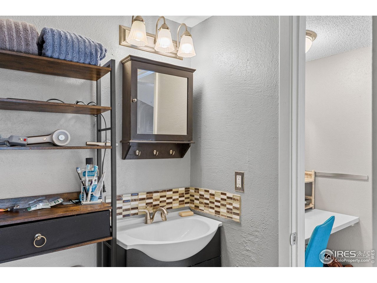4216 East Maplewood Way Centennial, CO 80121 - Photo 26 of 46 a bathroom with a sink a mirror and a toilet