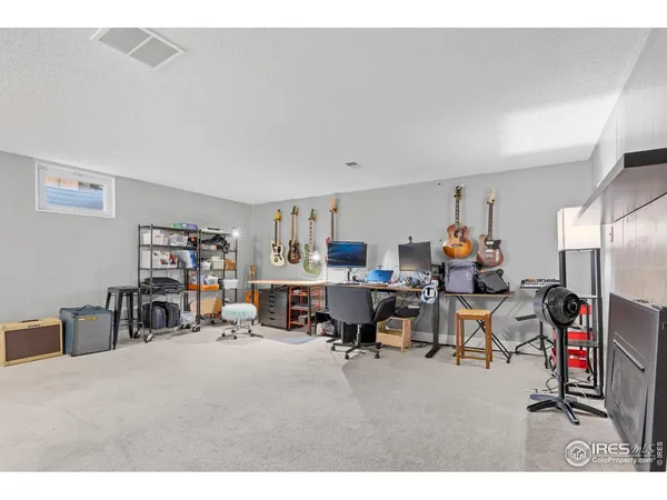a living room with furniture and a dining table