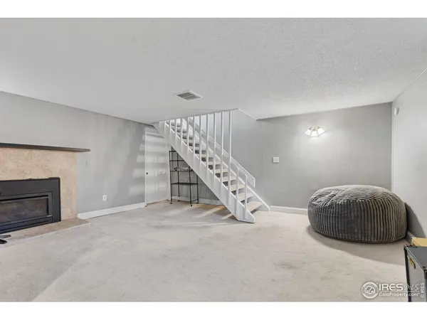 a living room with a furniture and a fireplace