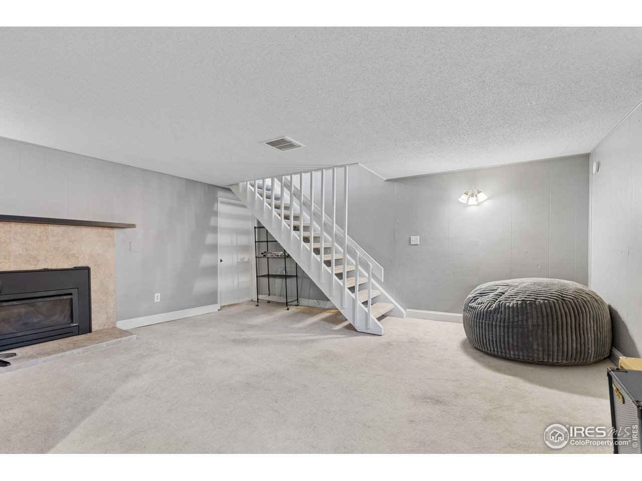 4216 East Maplewood Way Centennial, CO 80121 - Photo 34 of 46 a living room with a furniture and a fireplace
