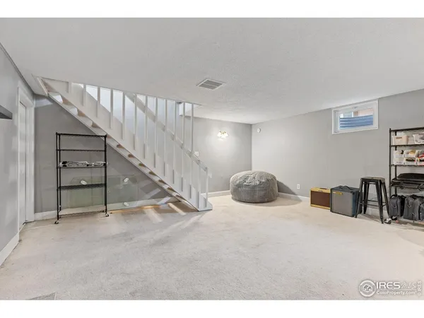 a view of a livingroom with furniture and staircase