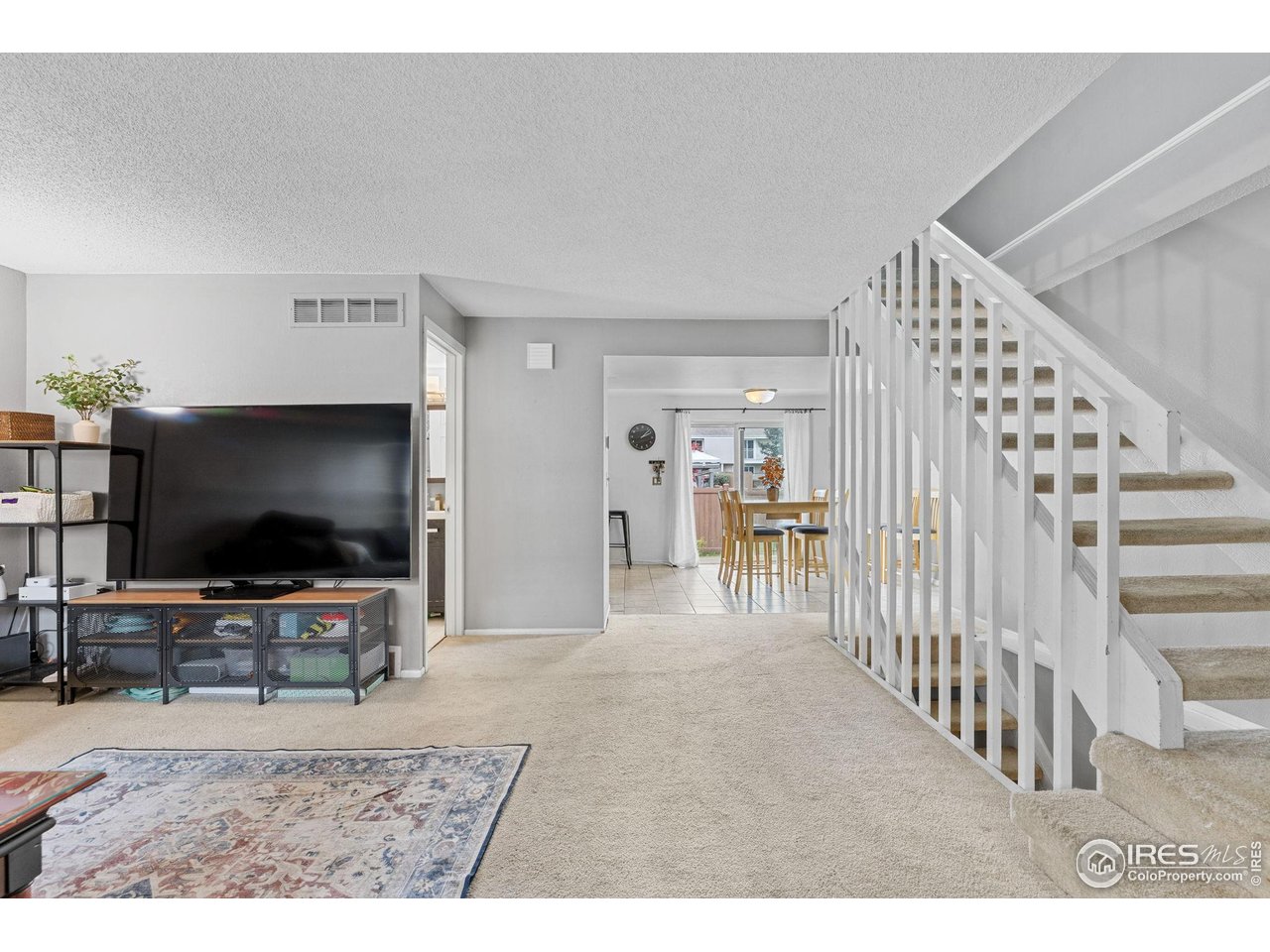 4216 East Maplewood Way Centennial, CO 80121 - Photo 10 of 46 a living room with furniture and a flat screen tv