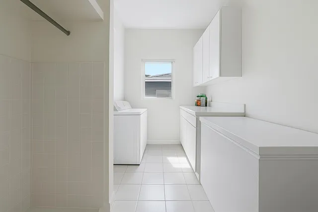 a kitchen with a sink a cabinetry and window