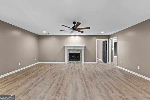 wooden floor in an empty room with a fireplace