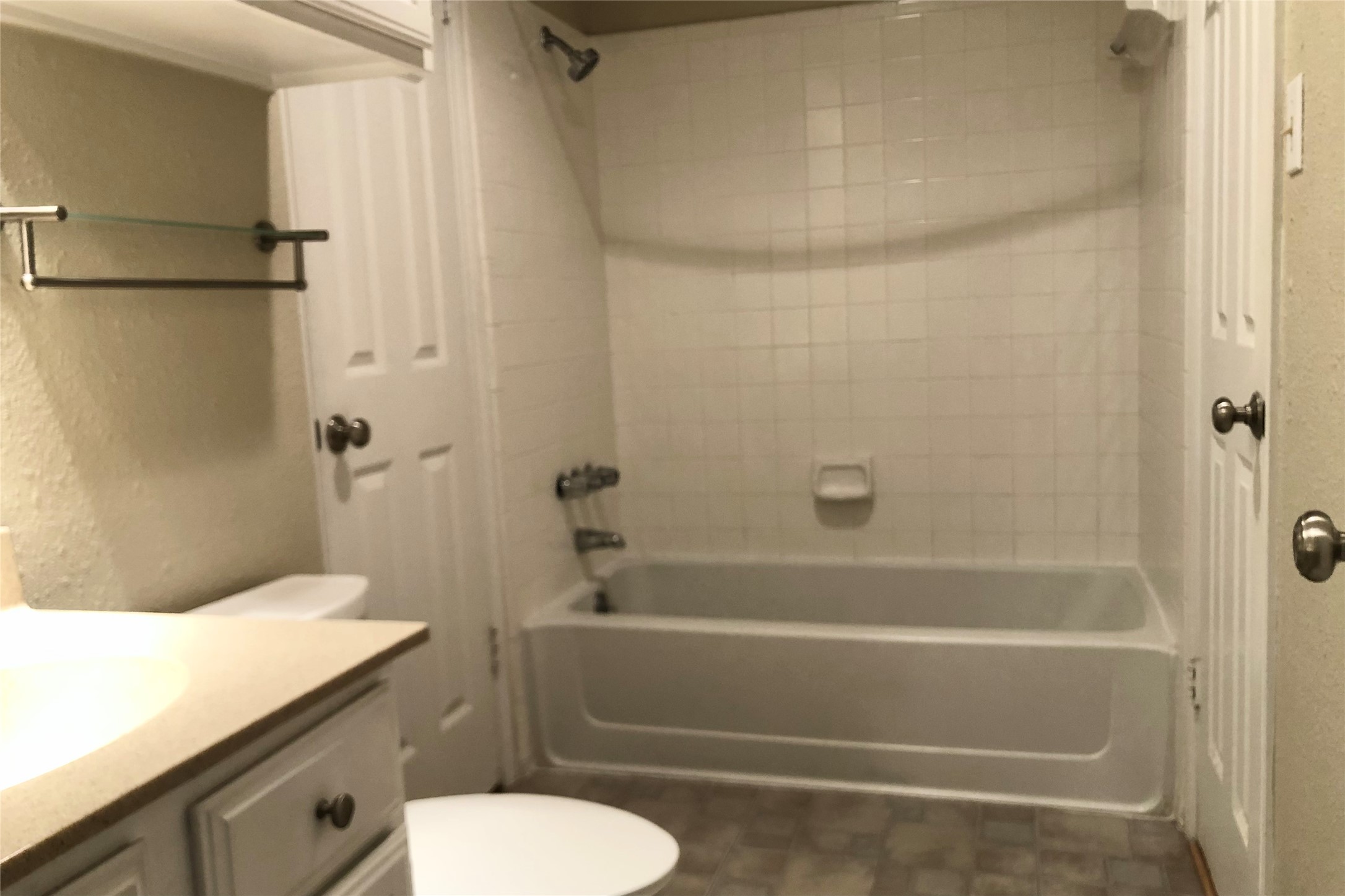 3111 Tom Green Street, Unit 204 Austin, TX 78705 - Photo 9 of 9 Bathroom with a textured wall, shower / bathtub combination, and vanity