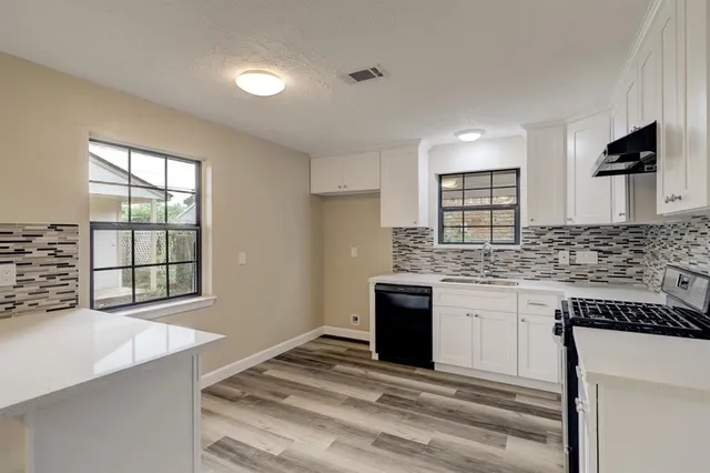 a kitchen with stainless steel appliances granite countertop a sink and a stove top oven