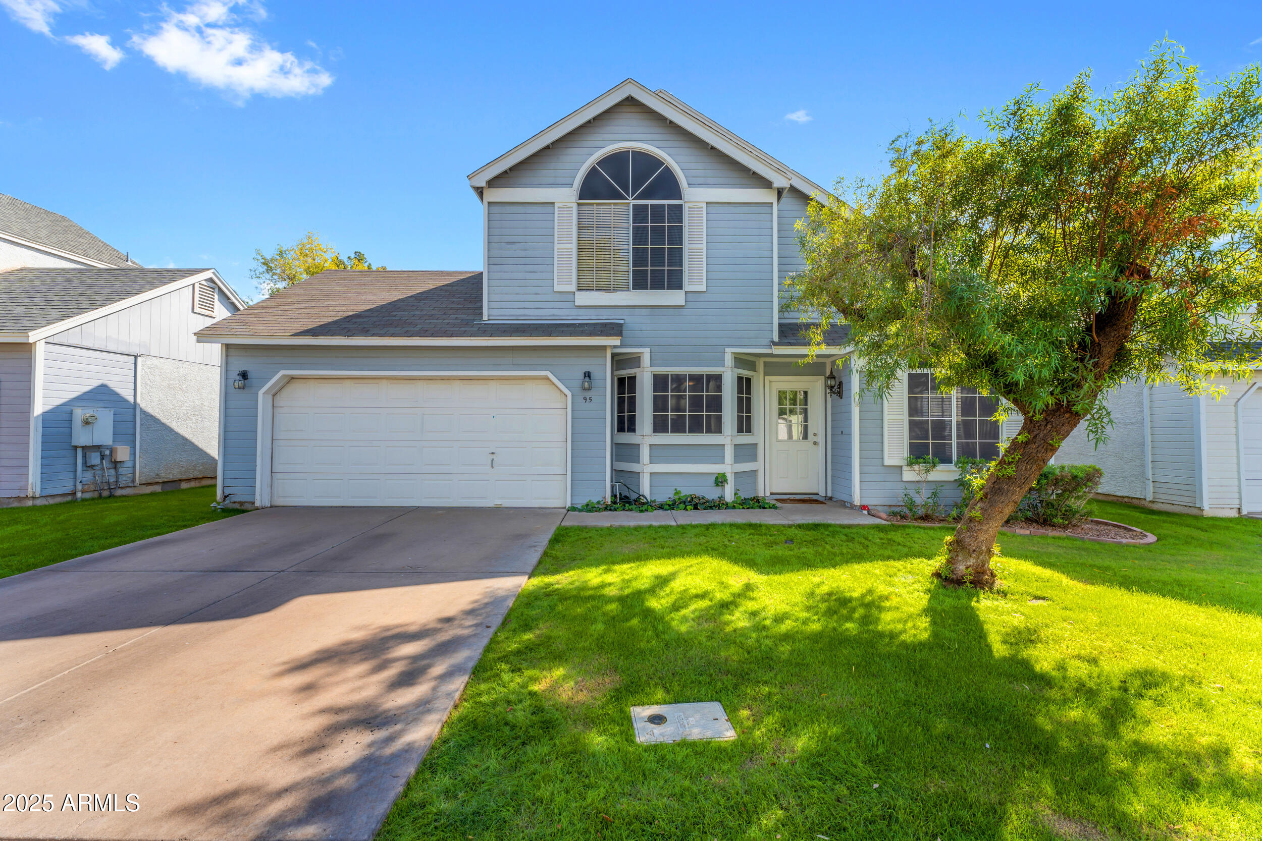 a front view of a house with yard and green space