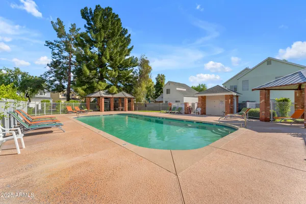 a front view of a house with a garden and tree