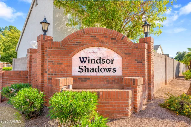 a sign that is on a brick wall