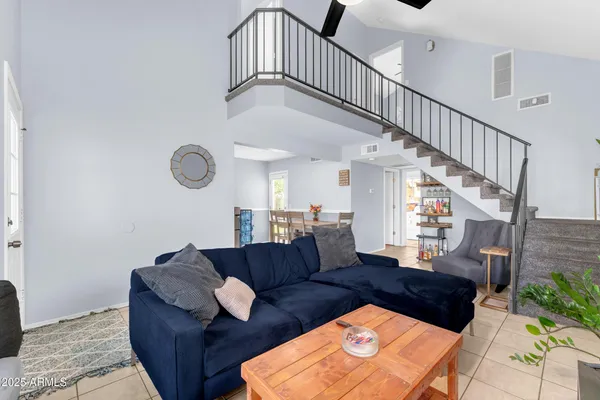 a living room with furniture and a potted plant
