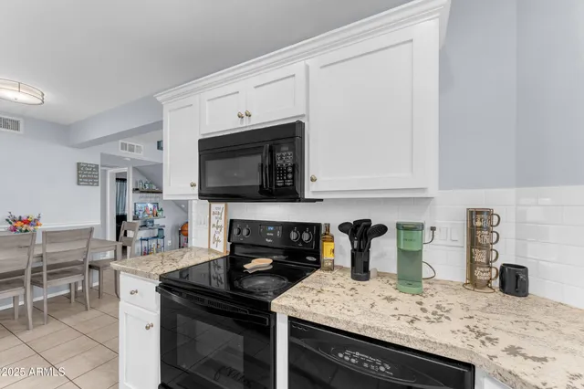 a kitchen with a stove and a white cabinets