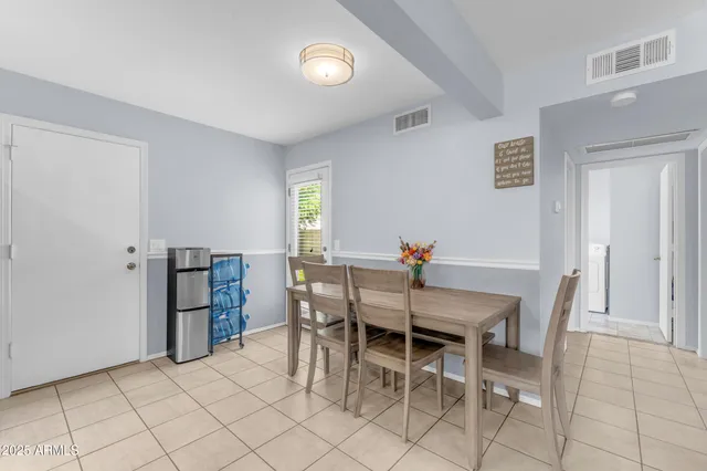 a dining room with furniture and window