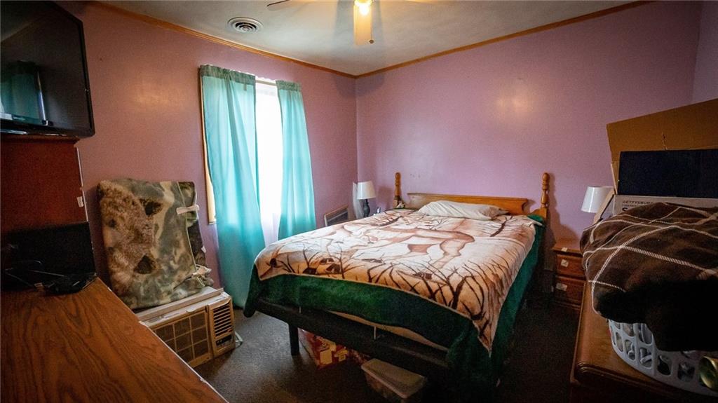 135 Hickory Street Butler, PA 16001 - Photo 14 of 25 a bedroom with a bed and a flat tv screen on the dresser