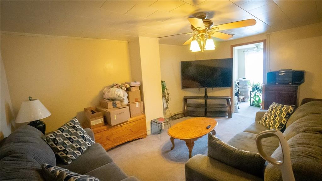 135 Hickory Street Butler, PA 16001 - Photo 16 of 25 a living room with furniture a flat screen tv and a floor to ceiling window