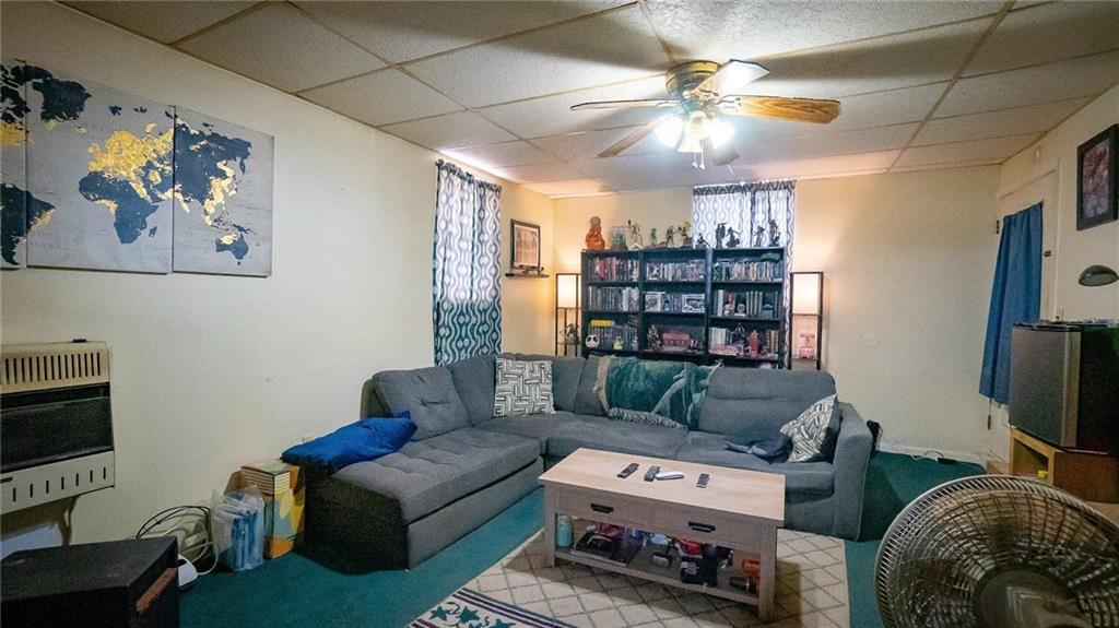 135 Hickory Street Butler, PA 16001 - Photo 8 of 25 a living room with furniture a couch and a bookshelf