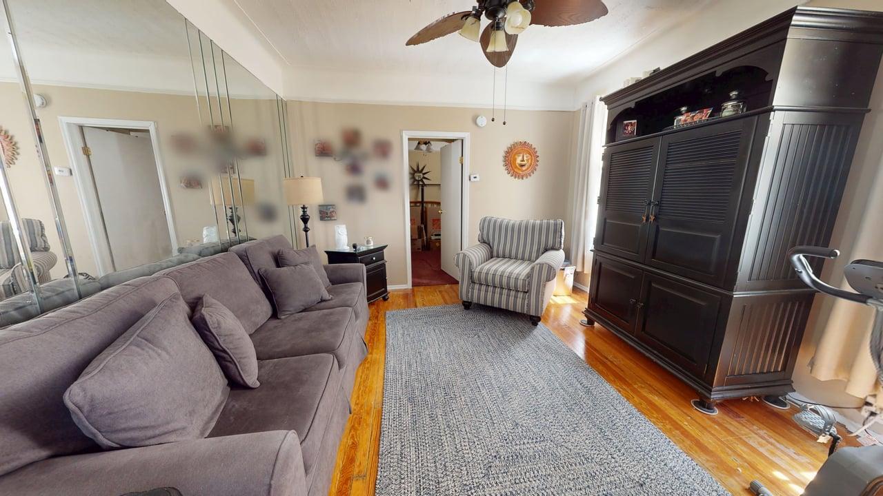 71-50 73rd Place Queens, NY 11385 - Photo 11 of 24 Living area featuring a ceiling fan and light wood-type flooring