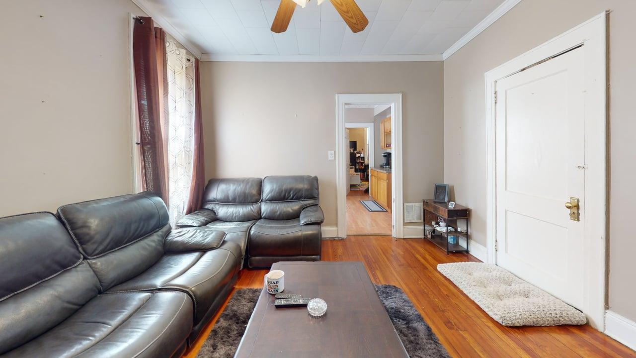 71-50 73rd Place Queens, NY 11385 - Photo 14 of 24 Living area featuring crown molding, visible vents, baseboards, a ceiling fan, and light wood finished floors