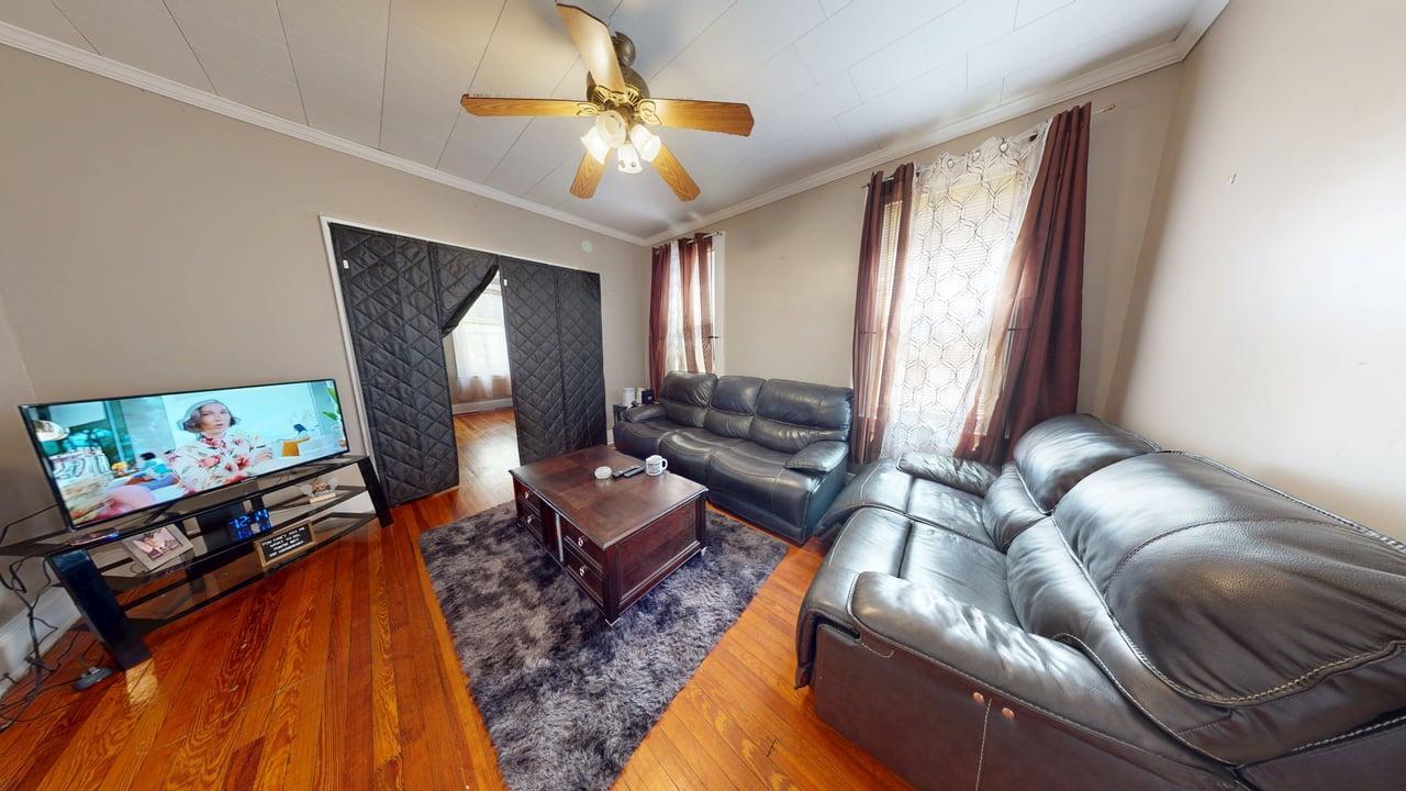 71-50 73rd Place Queens, NY 11385 - Photo 15 of 24 Living room featuring wood-type flooring, ornamental molding, and ceiling fan