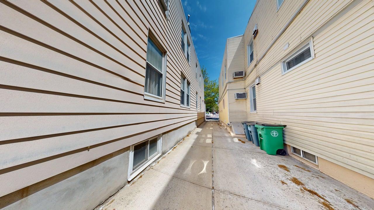71-50 73rd Place Queens, NY 11385 - Photo 18 of 24 View of side of home with a patio