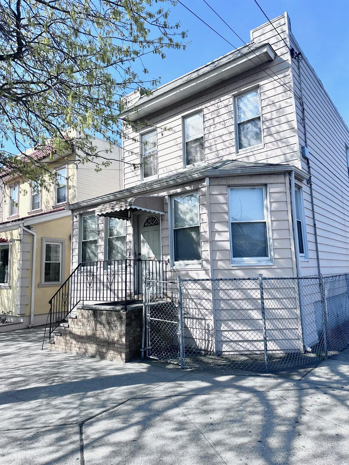 71-50 73rd Place Queens, NY 11385 - Photo 2 of 24 View of front of house featuring fence