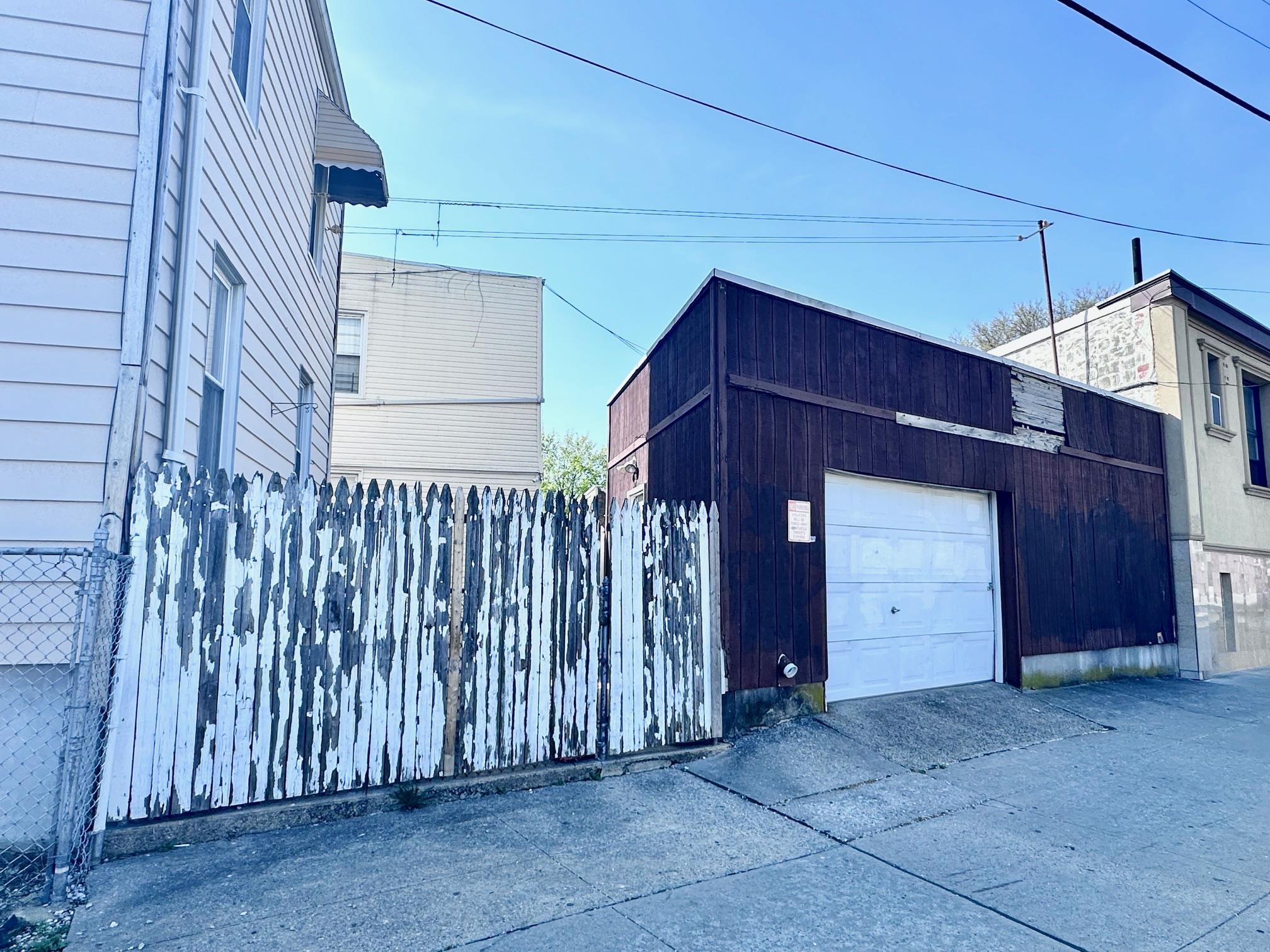 71-50 73rd Place Queens, NY 11385 - Photo 5 of 24 Garage with fence