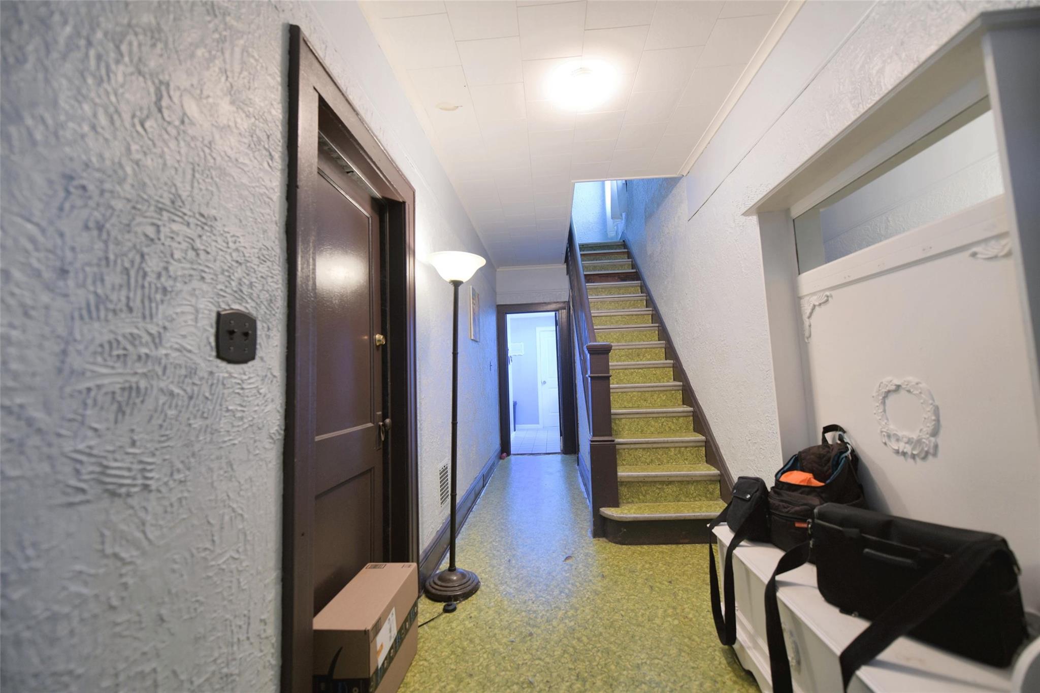 71-50 73rd Place Queens, NY 11385 - Photo 7 of 24 Hallway with baseboards and stairway