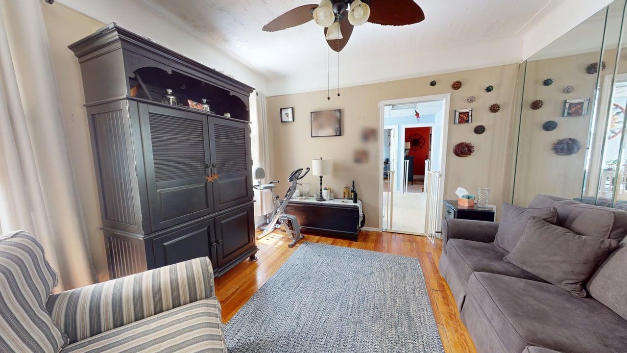 71-50 73rd Place Queens, NY 11385 - Photo 10 of 24 Living area featuring a ceiling fan and light wood finished floors