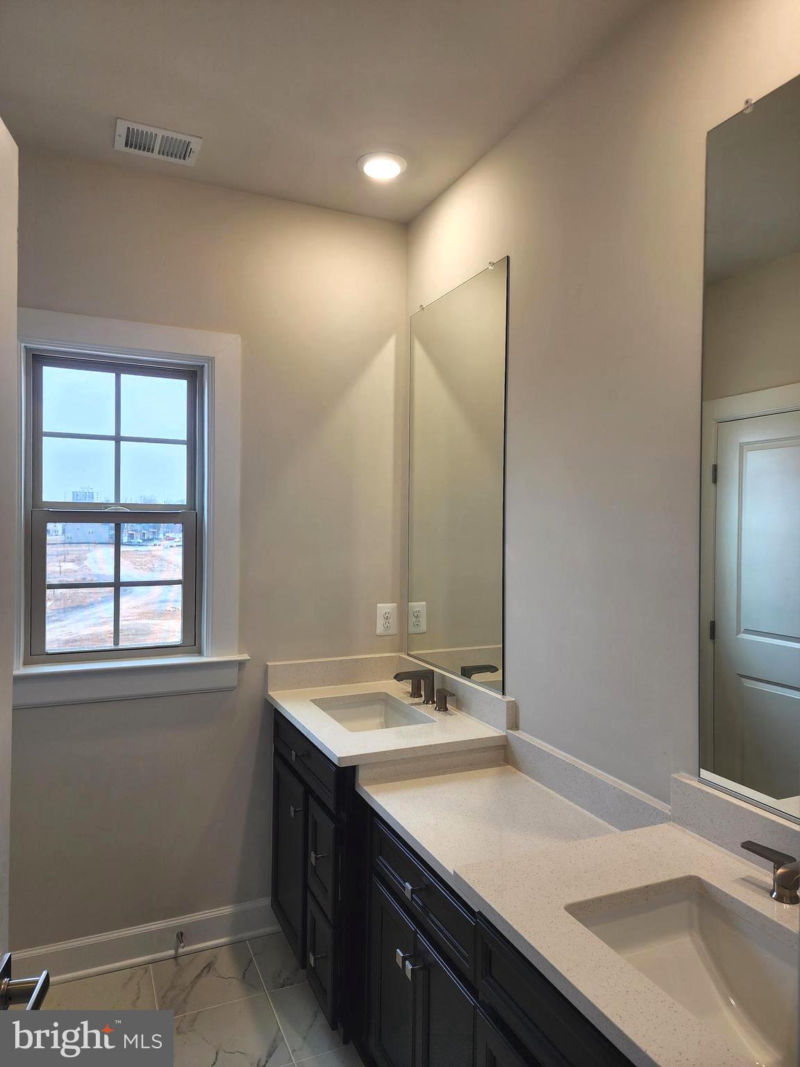 2111 Collington Place Laurel, MD 20708 - Photo 21 of 25 a bathroom with a sink and a mirror