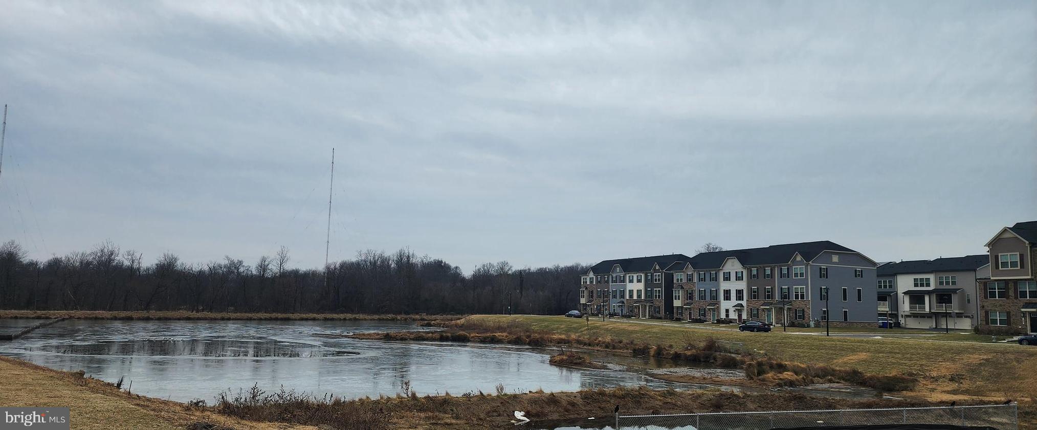 2111 Collington Place Laurel, MD 20708 - Photo 24 of 25 a view of a lake with a big yard and large trees