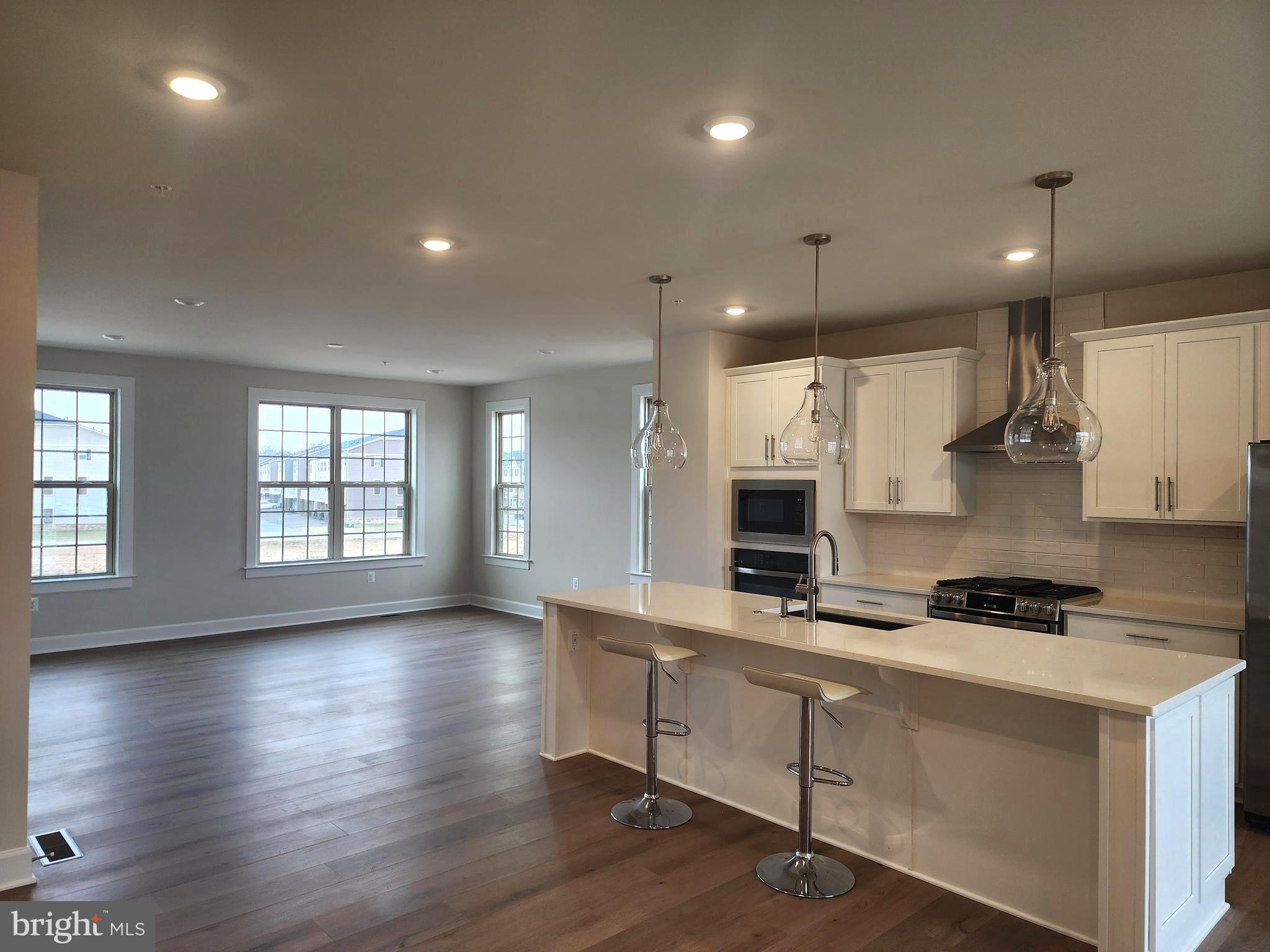 2111 Collington Place Laurel, MD 20708 - Photo 5 of 25 a kitchen with stainless steel appliances a stove a sink a microwave a refrigerator and cabinets