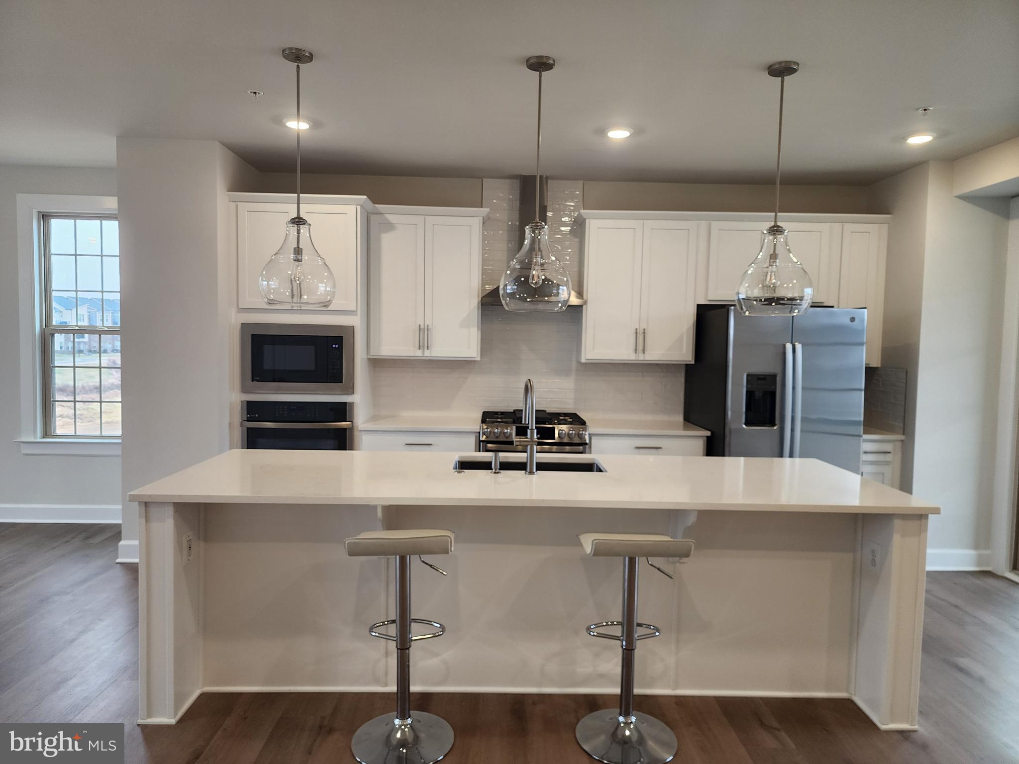 2111 Collington Place Laurel, MD 20708 - Photo 6 of 25 a kitchen with kitchen island a counter space a sink stainless steel appliances and cabinets