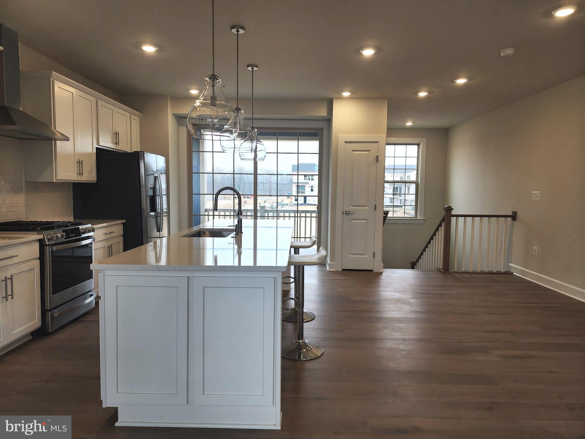 2111 Collington Place Laurel, MD 20708 - Photo 10 of 25 a kitchen with stainless steel appliances granite countertop a refrigerator a sink dishwasher a stove and a refrigerator with wooden floor
