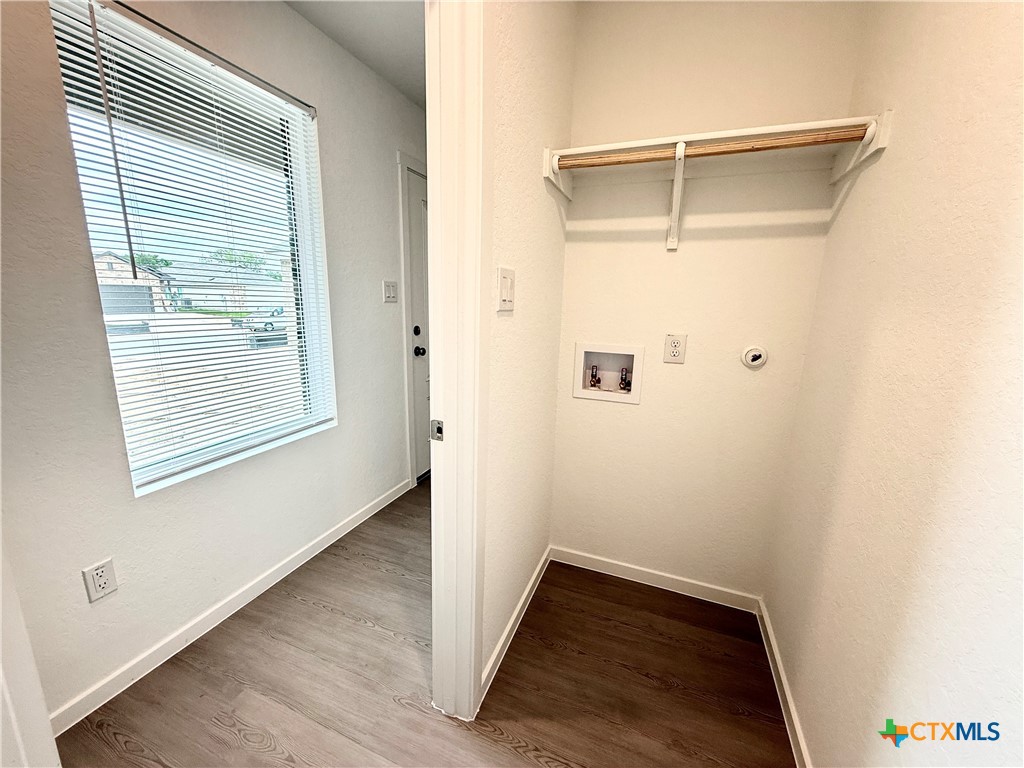 413 Moscato Road New Braunfels, TX 78130 - Photo 23 of 28 a view of an empty room with wooden floor and a window