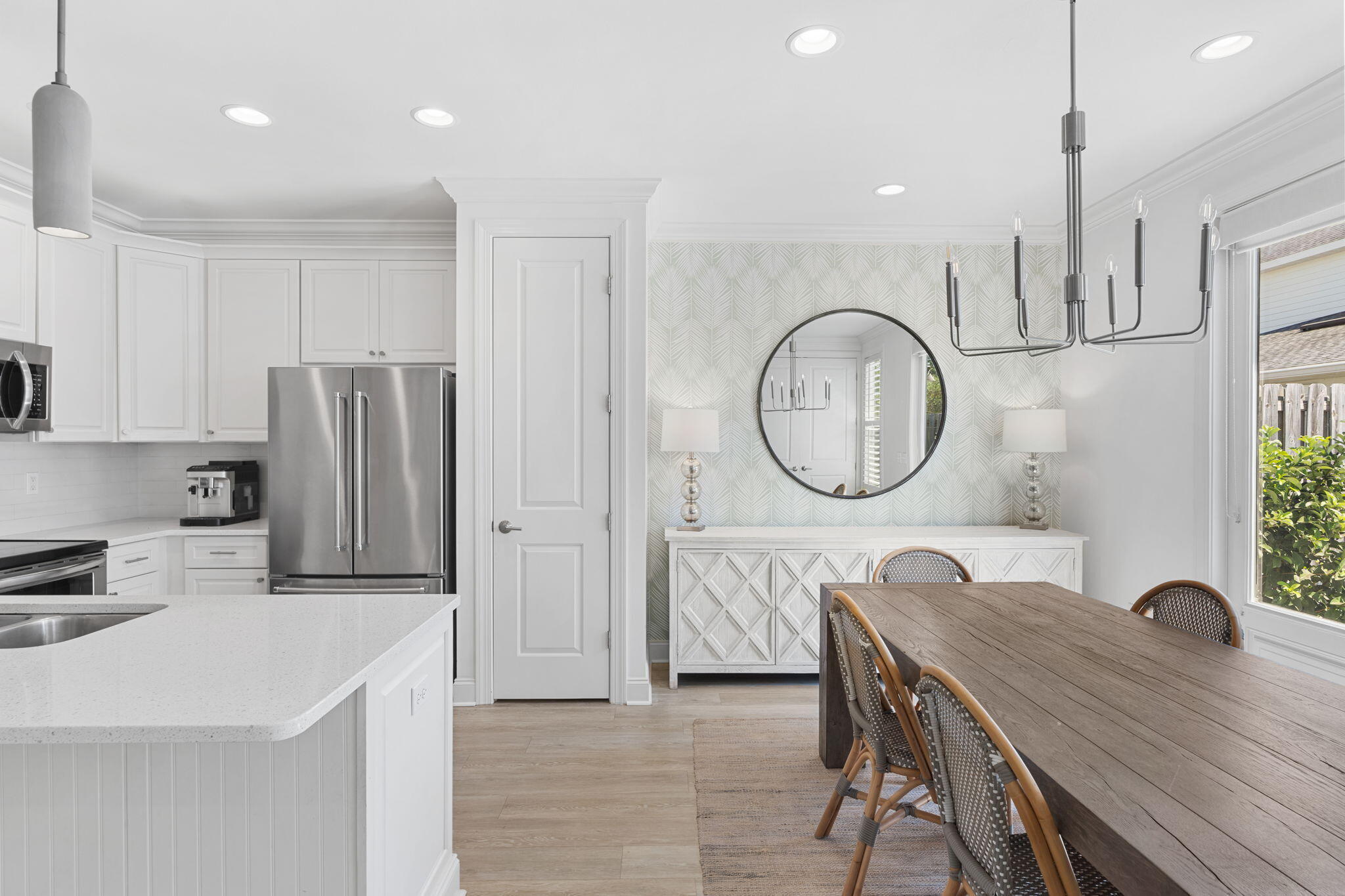 74 Chapman Street Santa Rosa Beach, FL 32459 - Photo 13 of 38 a kitchen with a table chairs a sink a window and stainless steel appliances