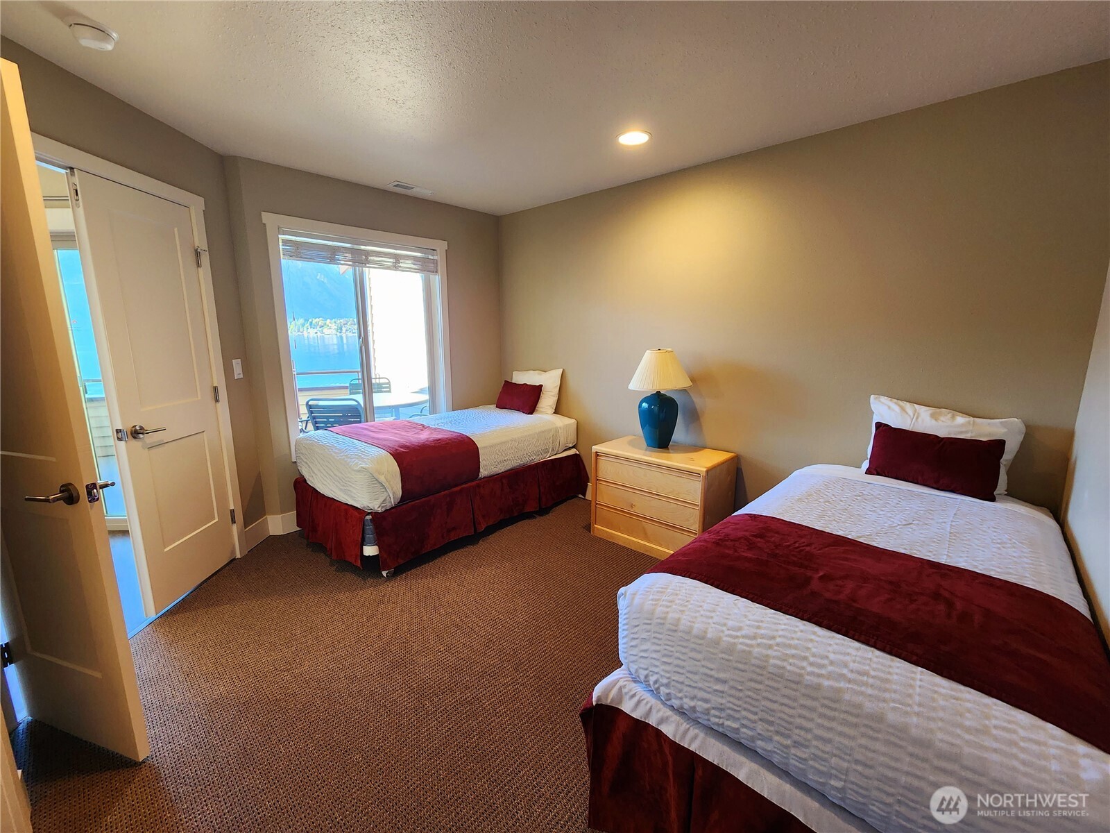 1 Lakeside 717-i Manson, WA 98831 - Photo 18 of 40 a spacious bedroom with two beds and a window